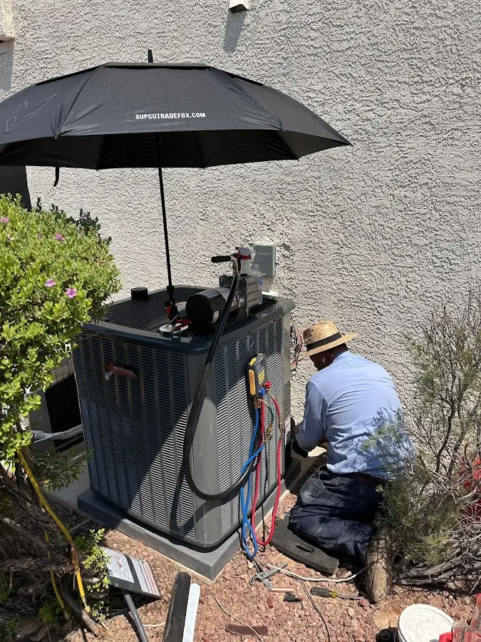 HVAC technician performing outdoor AC maintenance in Oakdale